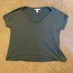 Cropped but can be tucked into high rise pants